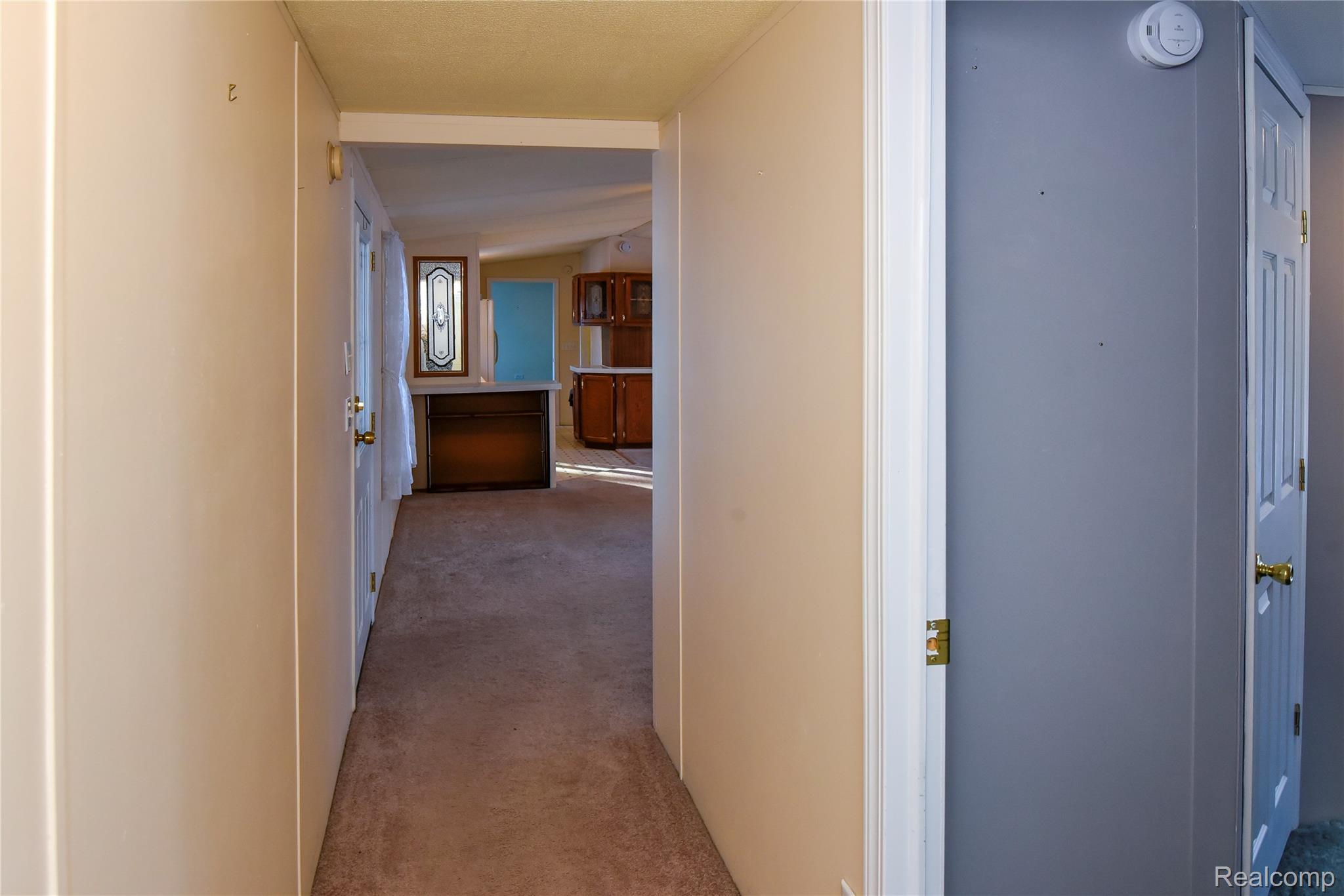 1094 Blamer Road Fairview, MI 48621 - Photo 56 of 97 Hallway featuring light colored carpet and vaulted ceiling