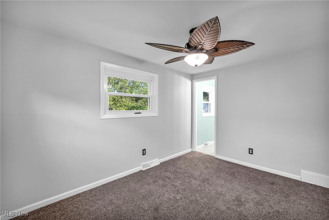 1135 Keefer Road Girard, OH 44420 - Photo 14 of 32 Empty room with carpet floors and ceiling fan
