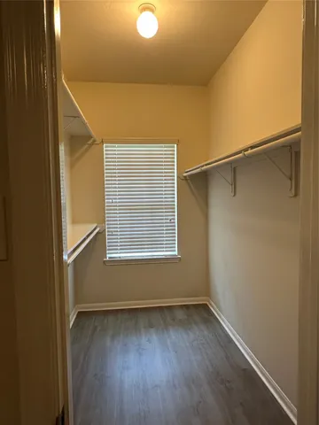 a view of a room with rack on the wall and a window