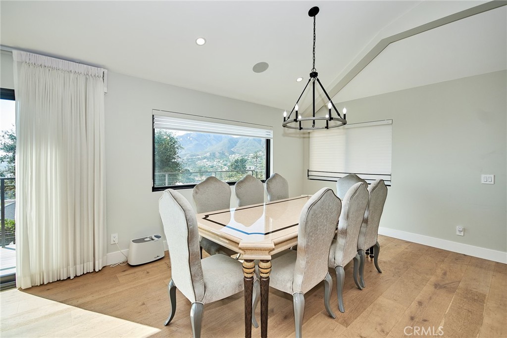 243 Notteargenta Road Pacific Palisades, CA 90272 - Photo 20 of 56 a dining room with furniture a chandelier and window