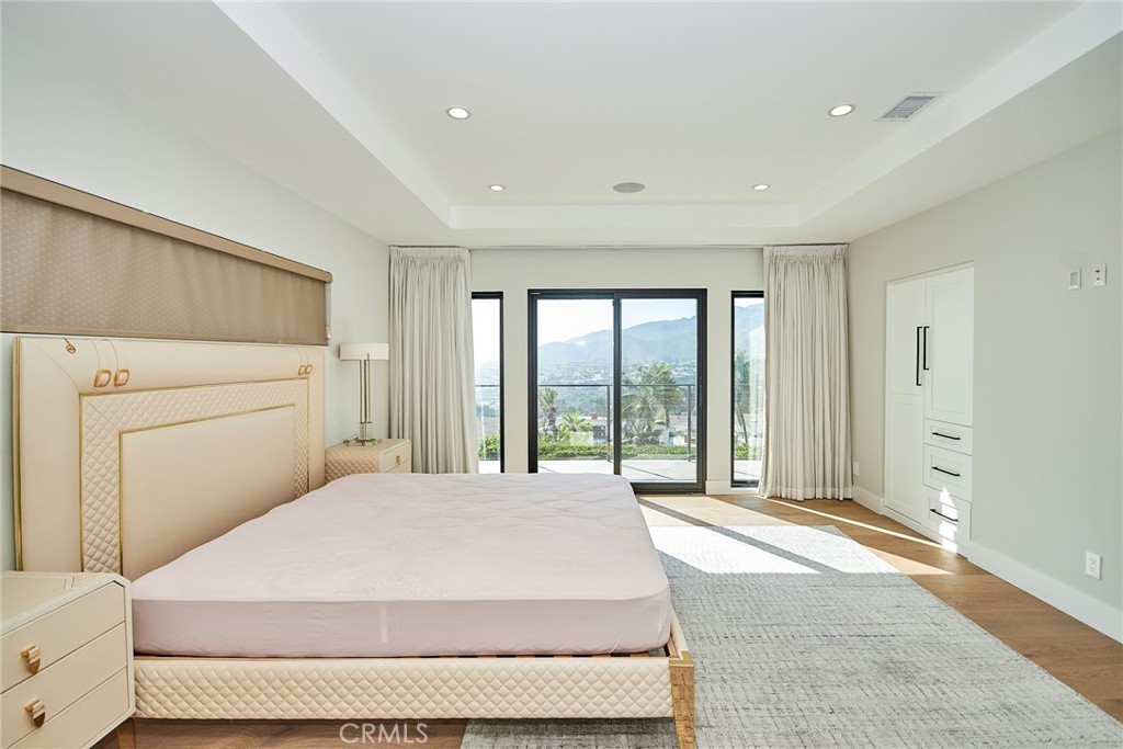 243 Notteargenta Road Pacific Palisades, CA 90272 - Photo 28 of 56 a bedroom with a large bed and a large window