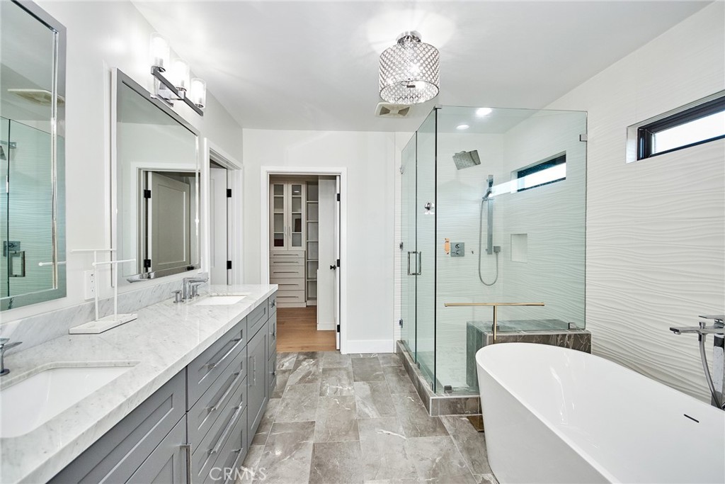243 Notteargenta Road Pacific Palisades, CA 90272 - Photo 33 of 56 a spacious bathroom with a tub sink shower and a mirror