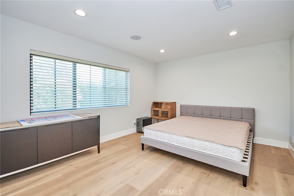 243 Notteargenta Road Pacific Palisades, CA 90272 - Photo 39 of 56 a bedroom with a bed and window