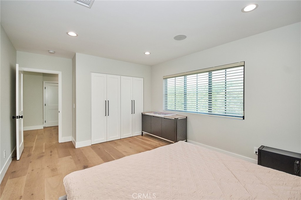 243 Notteargenta Road Pacific Palisades, CA 90272 - Photo 41 of 56 a bedroom with a bed and a window