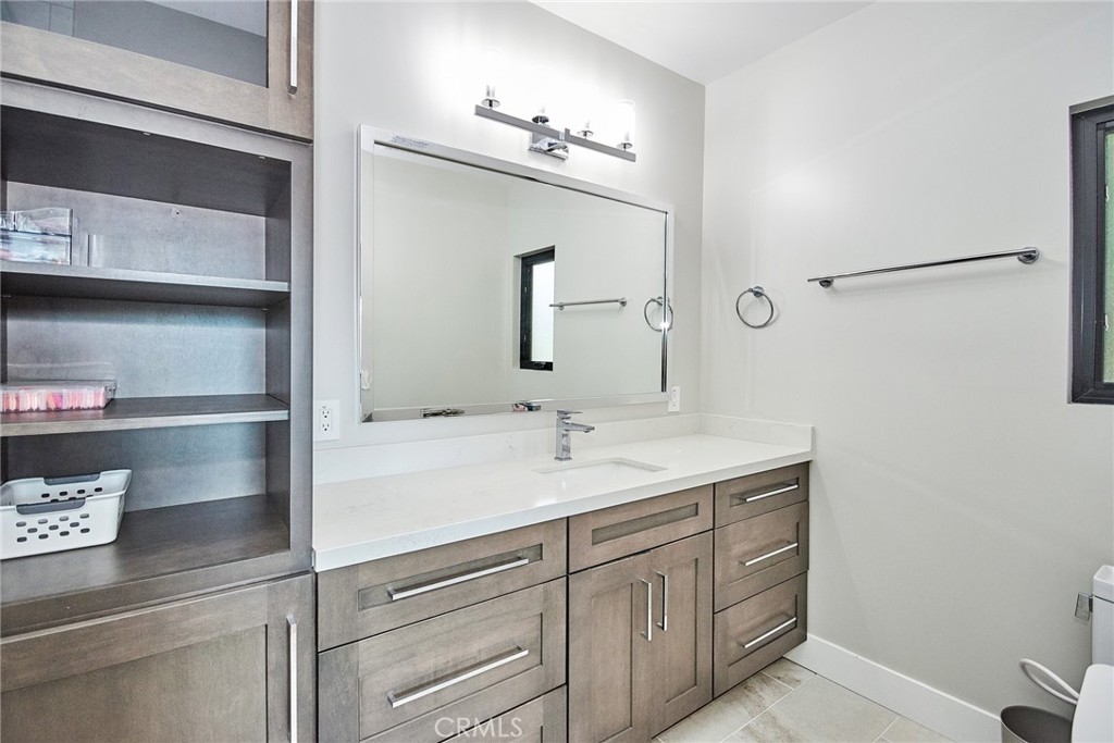243 Notteargenta Road Pacific Palisades, CA 90272 - Photo 46 of 56 a bathroom with a sink and a mirror