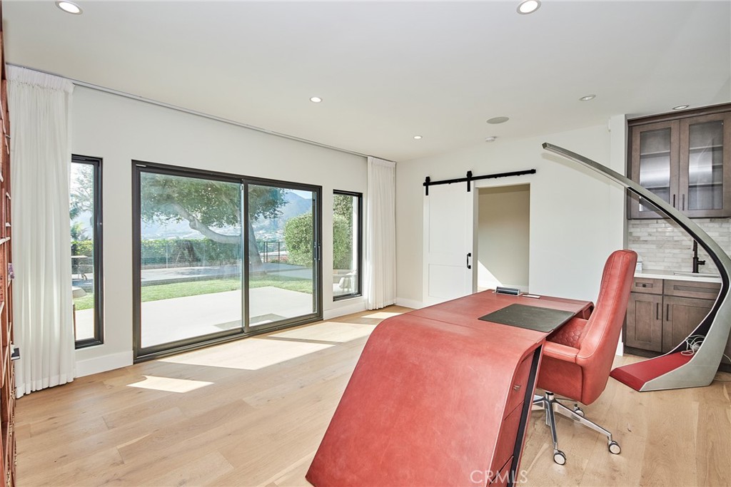 243 Notteargenta Road Pacific Palisades, CA 90272 - Photo 48 of 56 a bedroom with a bed and large windows