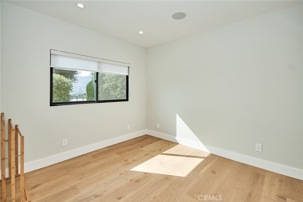 243 Notteargenta Road Pacific Palisades, CA 90272 - Photo 50 of 56 an empty room with wooden floor and windows