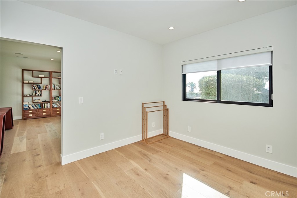 243 Notteargenta Road Pacific Palisades, CA 90272 - Photo 51 of 56 an empty room with wooden floor and windows