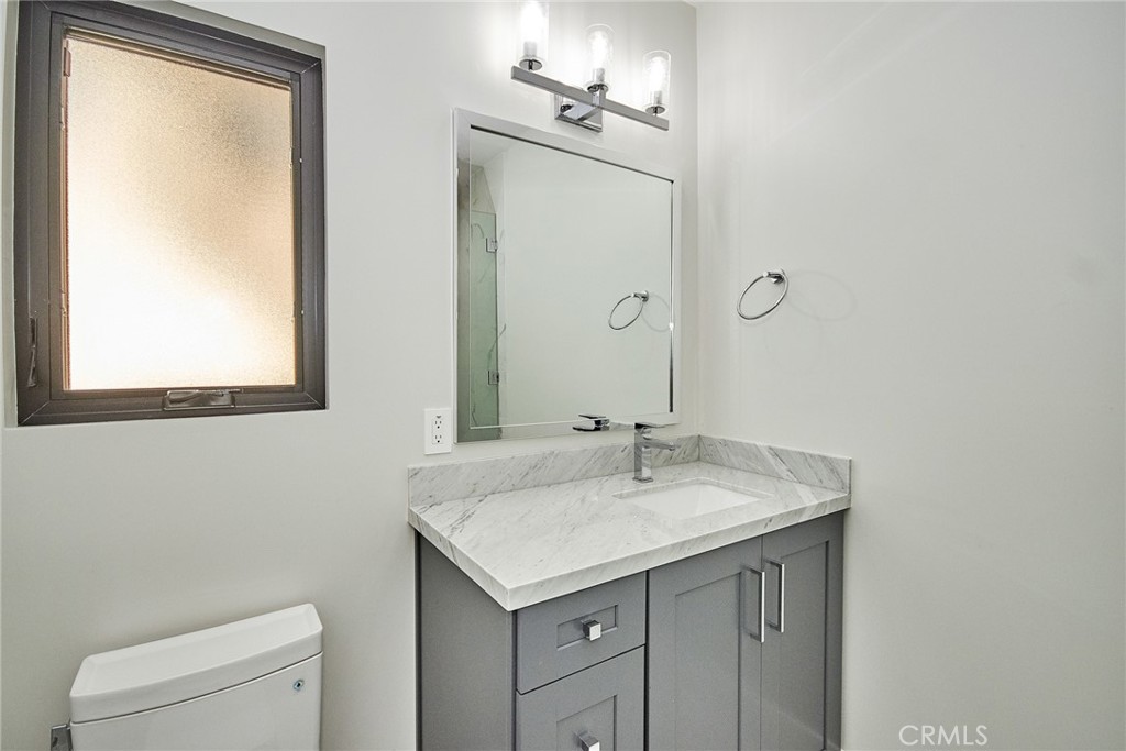 243 Notteargenta Road Pacific Palisades, CA 90272 - Photo 53 of 56 a bathroom with a sink a toilet and mirror
