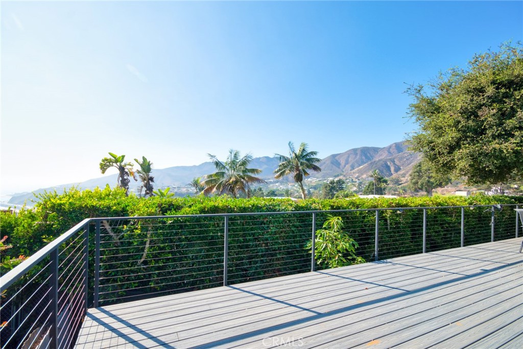 243 Notteargenta Road Pacific Palisades, CA 90272 - Photo 56 of 56 a view of a balcony with floor to ceiling windows and wooden fence