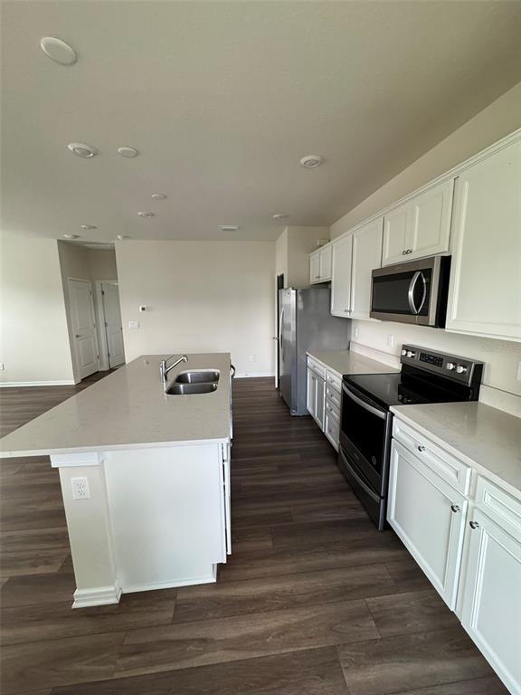 6350 Rover Way St. Cloud, FL 34771 - Photo 5 of 14 a large white kitchen with wooden floor
