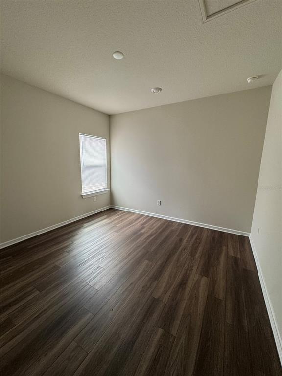 6350 Rover Way St. Cloud, FL 34771 - Photo 9 of 14 wooden floor in an empty room with a window