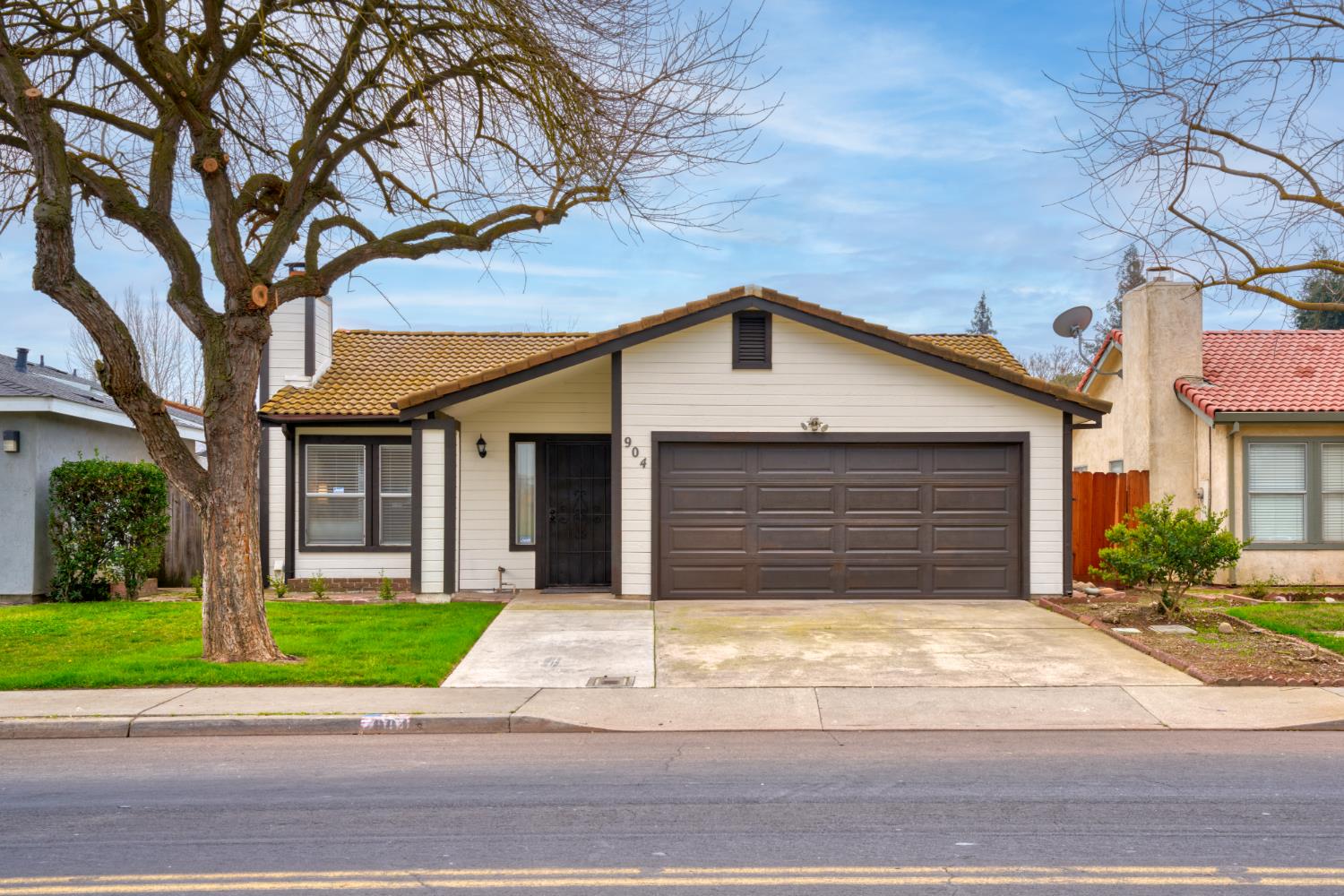 904 West Union Avenue Modesto, CA 95356 - Photo 1 of 1 a front view of a house with a yard and garage