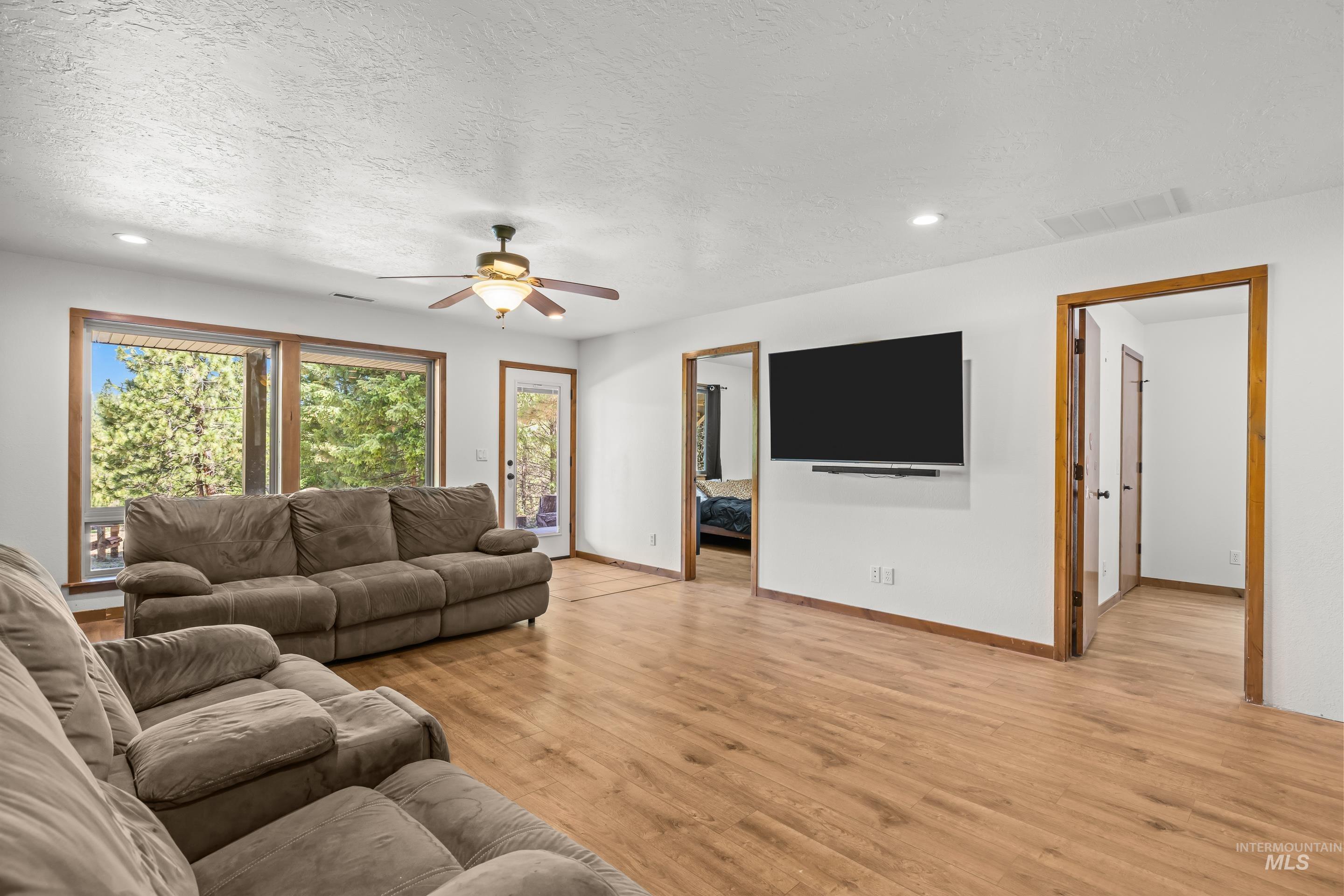 92 Cruickshank Road Horseshoe Bend, ID 83629 - Photo 31 of 50 Bright living area featuring wood-finish flooring and ample natural light from extensive window views