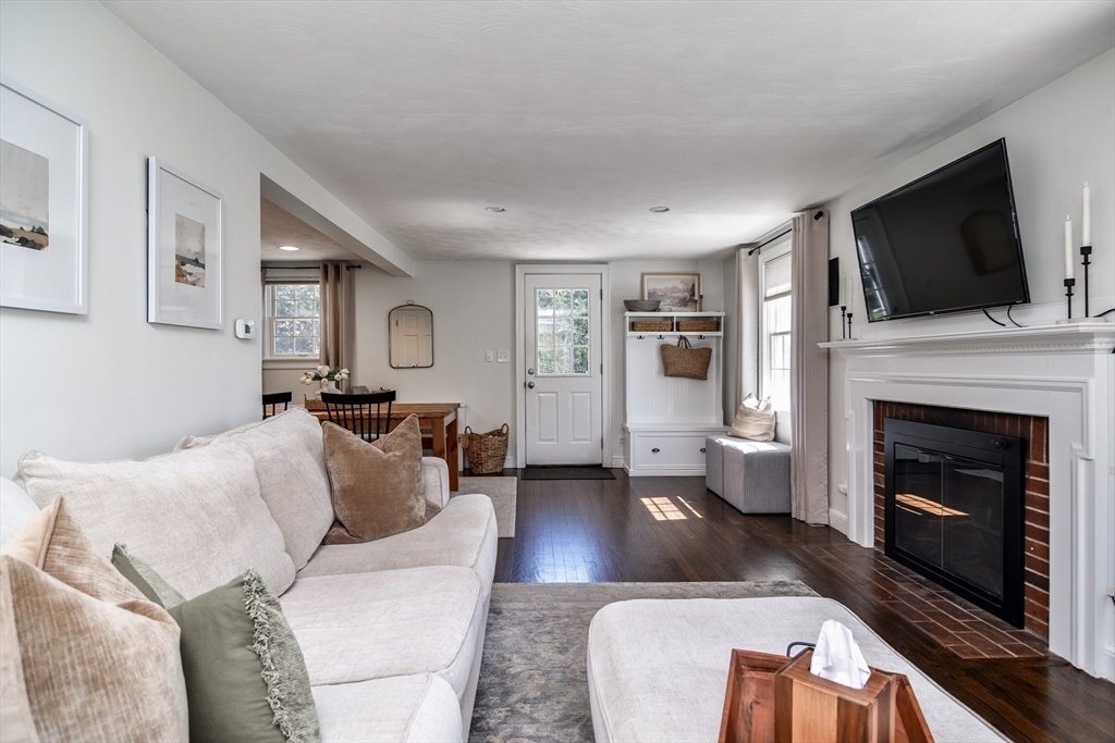 52 Wesley Road Framingham, MA 01701 - Photo 3 of 29 a living room with furniture a flat screen tv and a fireplace