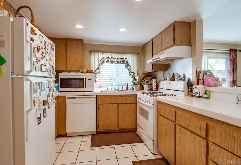 2010 Bridgeport Chula Vista, CA 91913 - Photo 14 of 43 a kitchen with stainless steel appliances granite countertop a refrigerator sink and microwave
