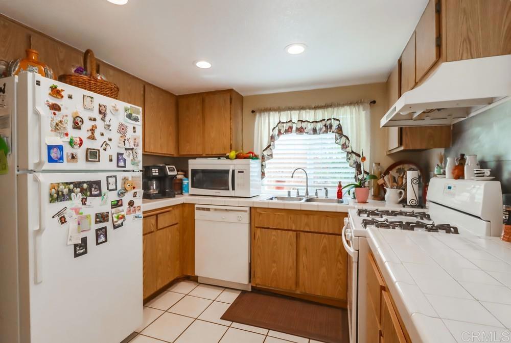 2010 Bridgeport Chula Vista, CA 91913 - Photo 15 of 43 a kitchen with stainless steel appliances a refrigerator and a stove top oven