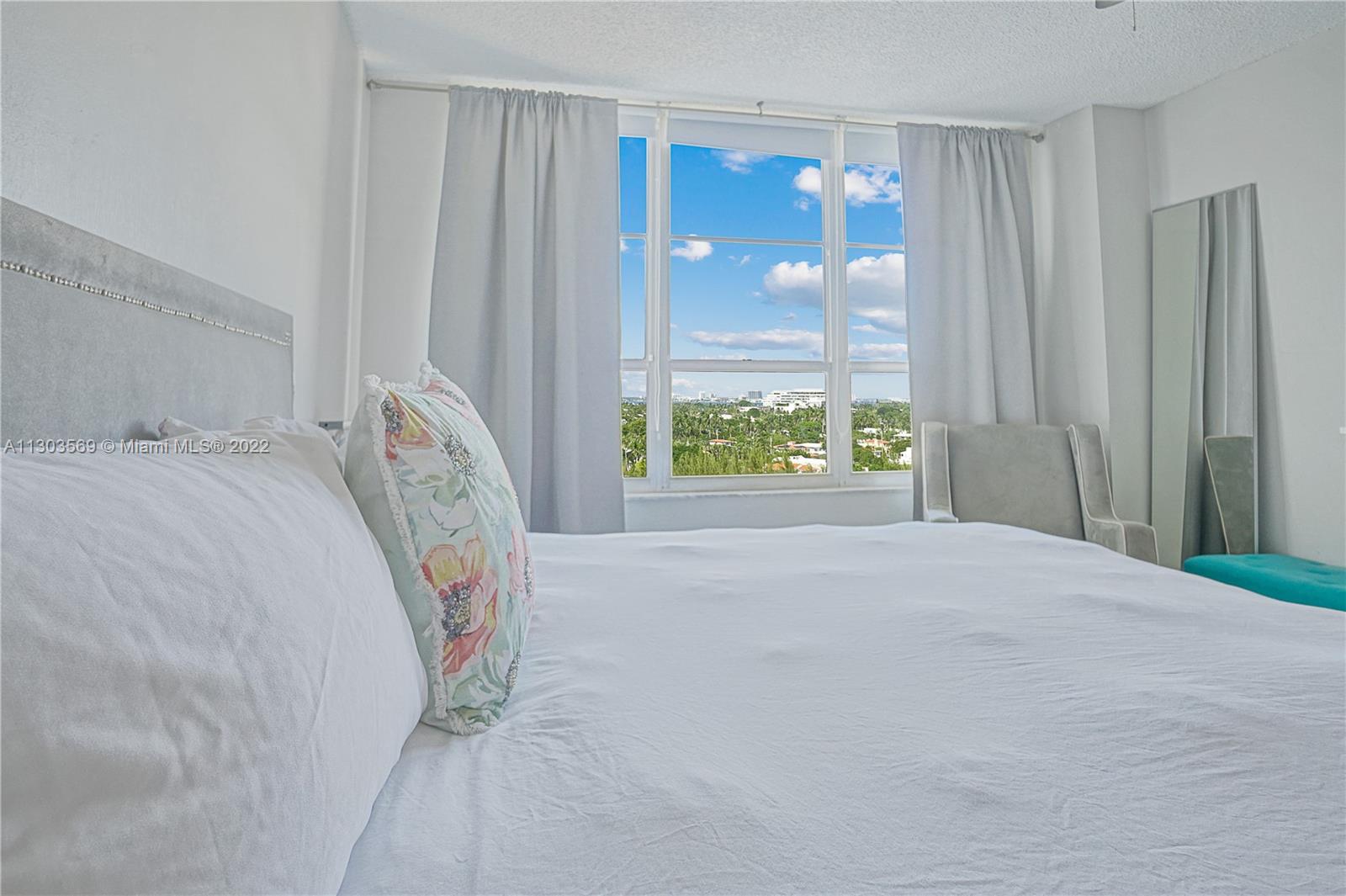 4101 Pine Tree Drive, Unit 908 Miami Beach, FL 33140 - Photo 20 of 41 a bedroom with a bed and a window