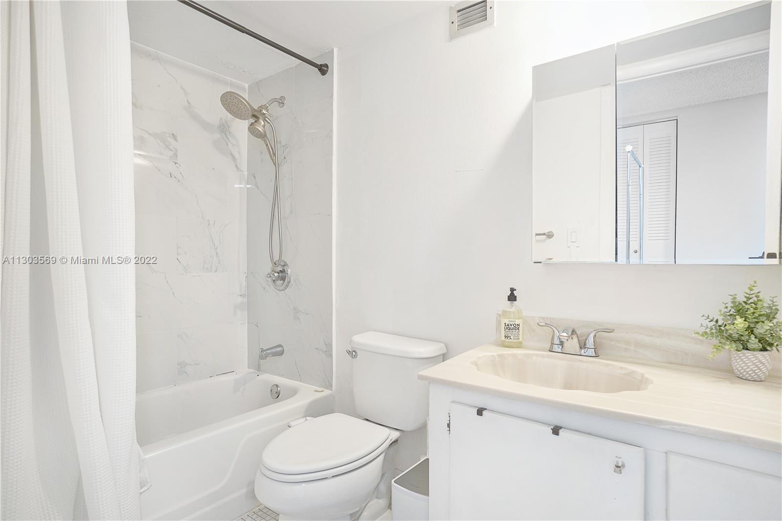 4101 Pine Tree Drive, Unit 908 Miami Beach, FL 33140 - Photo 21 of 41 a bathroom with a sink a toilet and shower