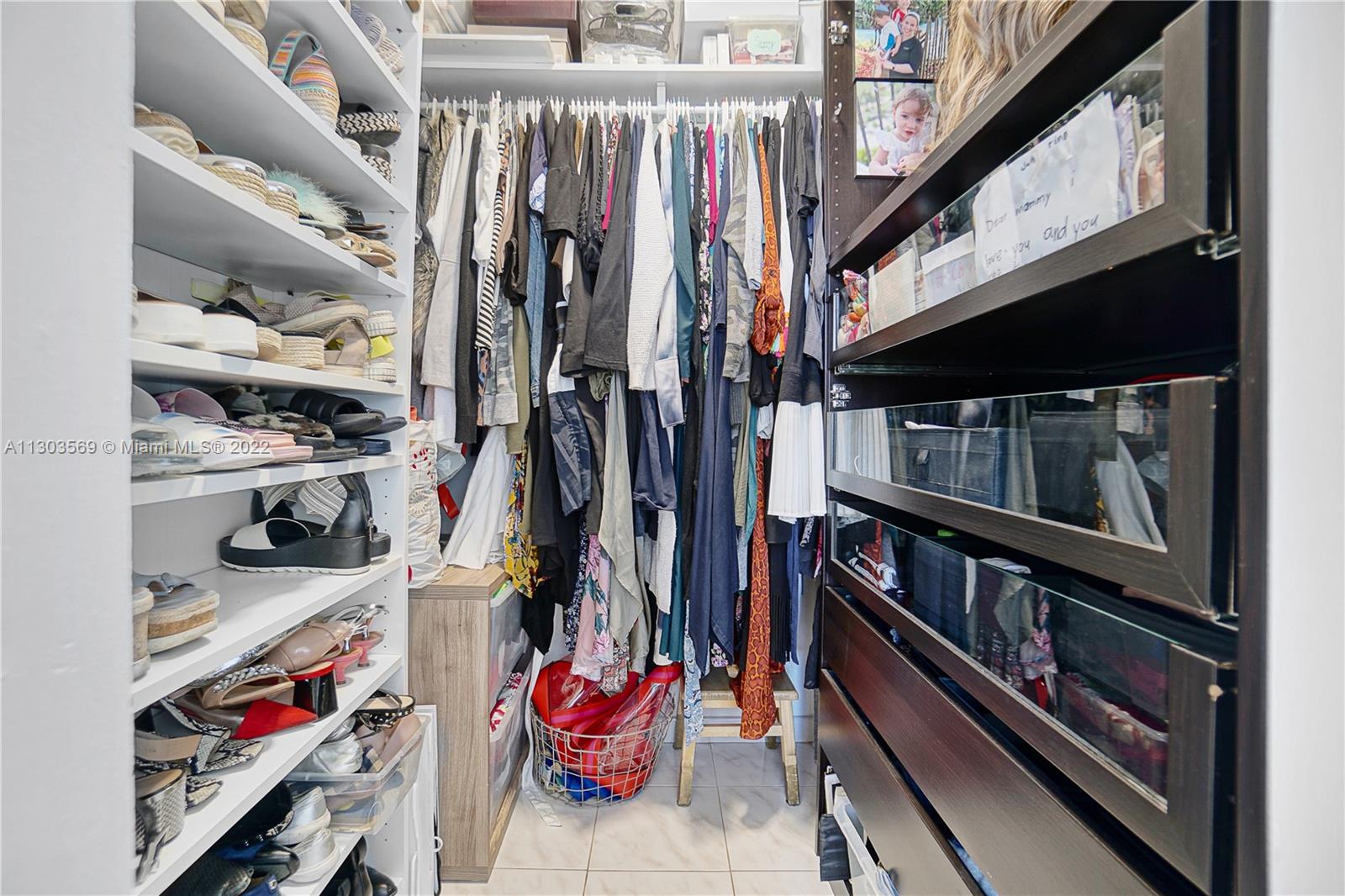 4101 Pine Tree Drive, Unit 908 Miami Beach, FL 33140 - Photo 22 of 41 a view of walk in closet with clothes and shoes