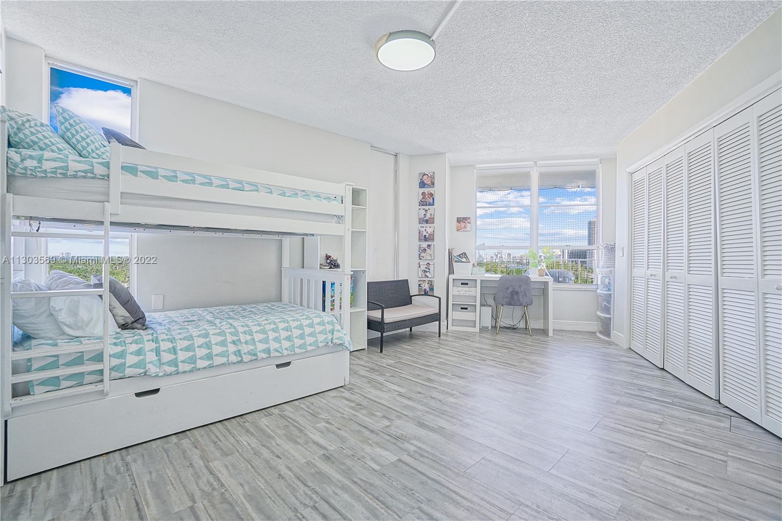 4101 Pine Tree Drive, Unit 908 Miami Beach, FL 33140 - Photo 23 of 41 a bedroom with furniture and a window