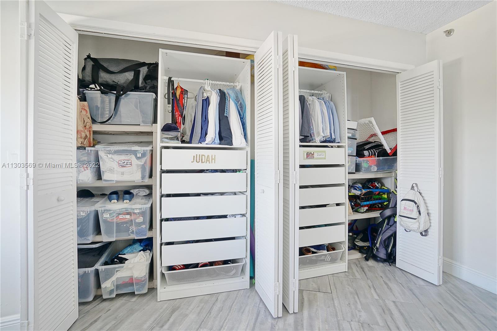 4101 Pine Tree Drive, Unit 908 Miami Beach, FL 33140 - Photo 24 of 41 a view of walk in closet with clothes and shoes