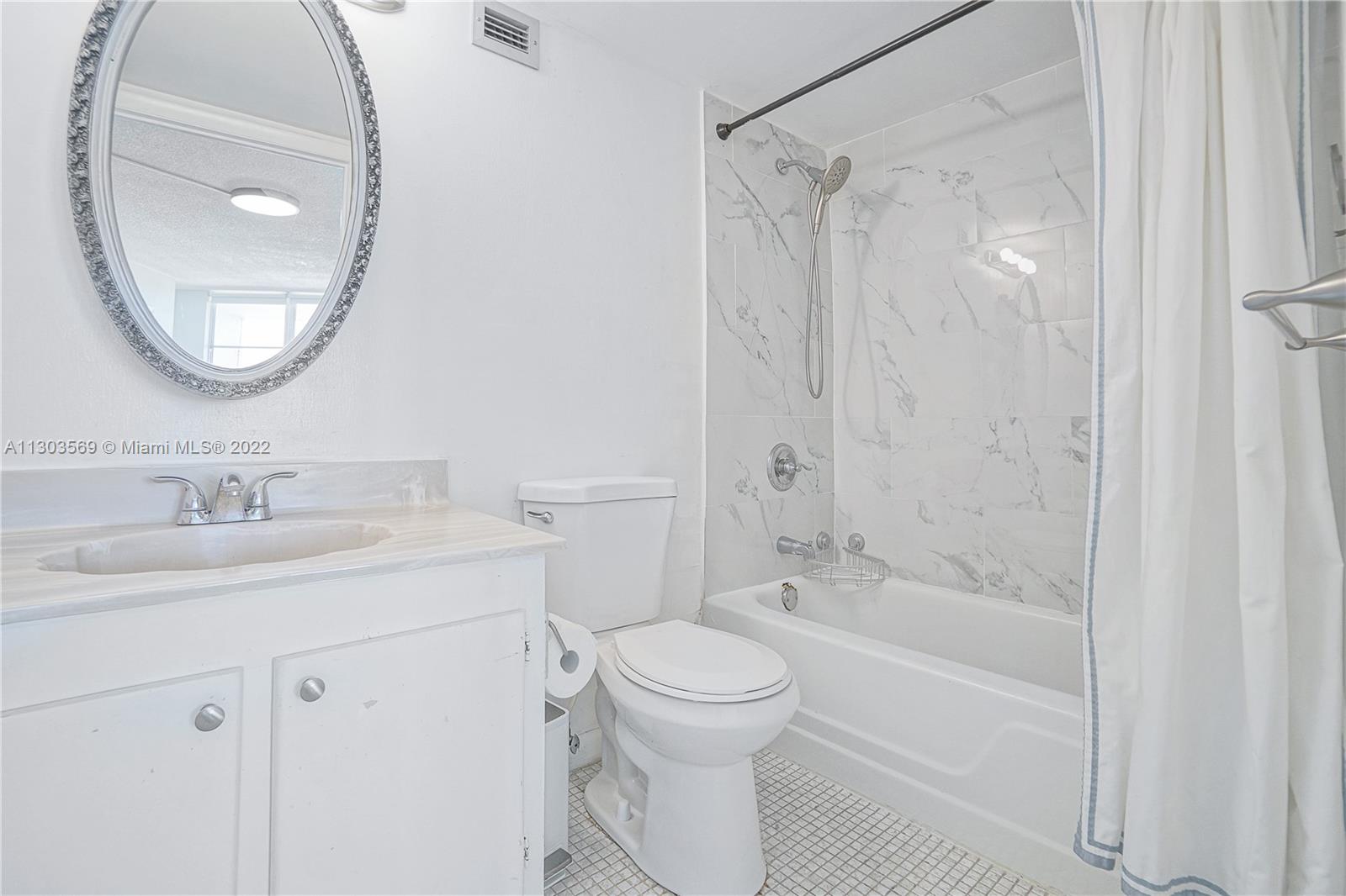 4101 Pine Tree Drive, Unit 908 Miami Beach, FL 33140 - Photo 25 of 41 a bathroom with a sink toilet and shower