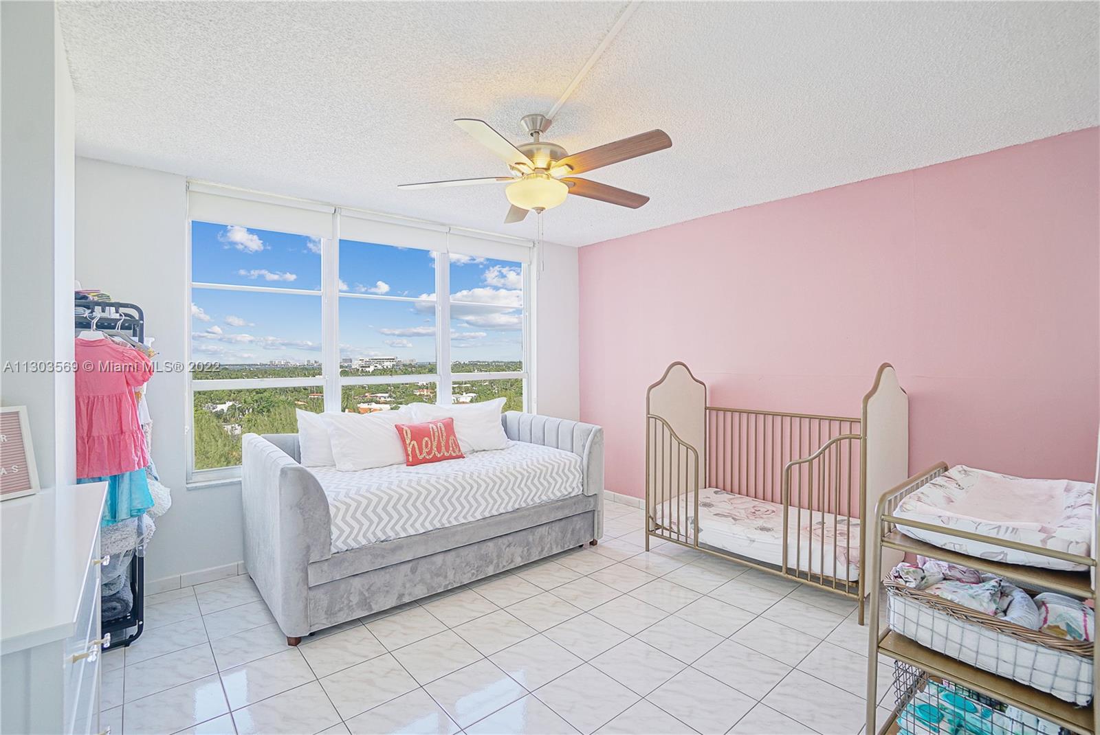 4101 Pine Tree Drive, Unit 908 Miami Beach, FL 33140 - Photo 26 of 41 a living room with furniture a chandelier and a window