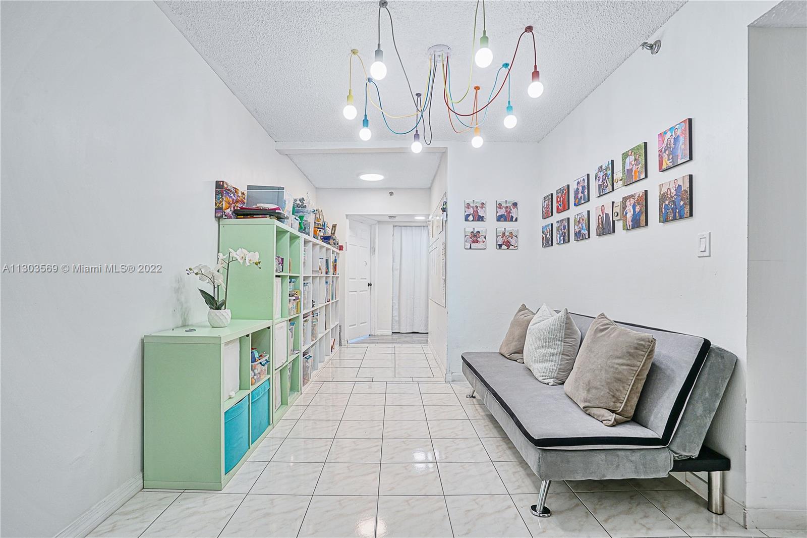 4101 Pine Tree Drive, Unit 908 Miami Beach, FL 33140 - Photo 31 of 41 a living room with furniture and a chandelier