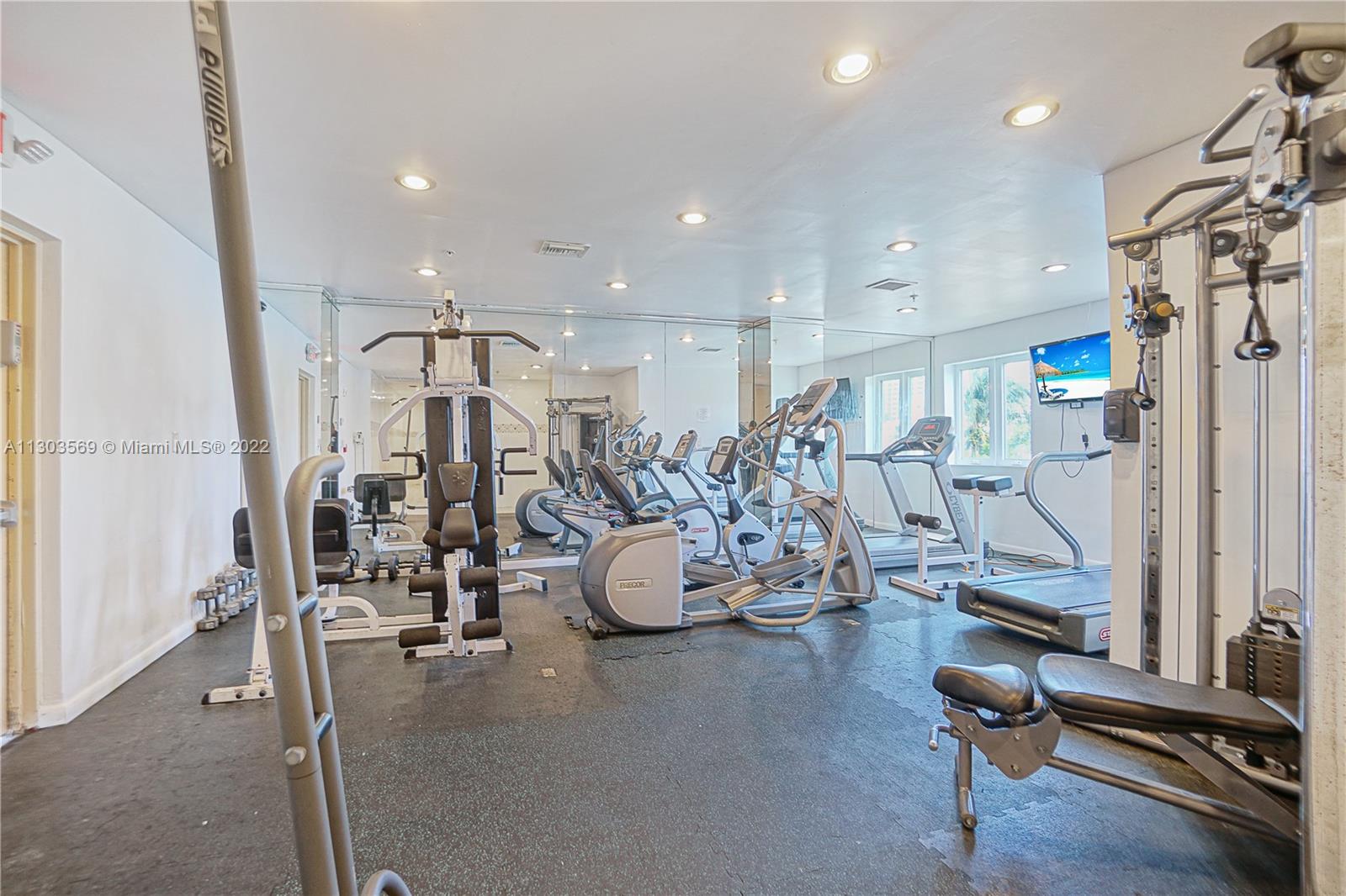 4101 Pine Tree Drive, Unit 908 Miami Beach, FL 33140 - Photo 34 of 41 a view of a room with gym equipment