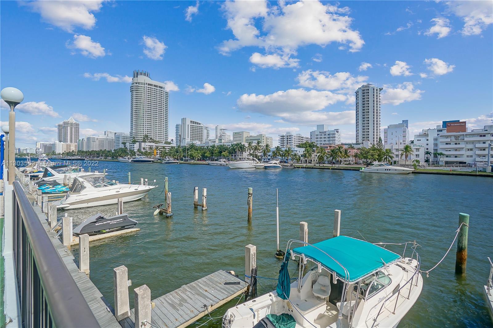 4101 Pine Tree Drive, Unit 908 Miami Beach, FL 33140 - Photo 37 of 41 a view of a lake with tall buildings