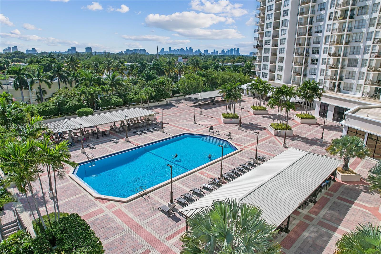 4101 Pine Tree Drive, Unit 908 Miami Beach, FL 33140 - Photo 6 of 41 a view of a swimming pool with outdoor seating and plants