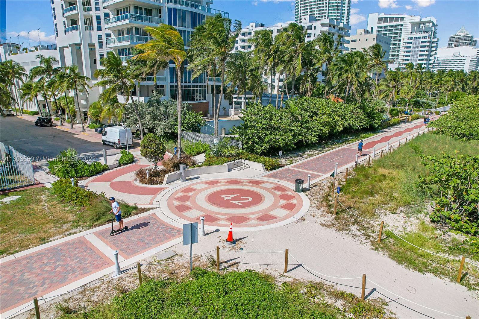 4101 Pine Tree Drive, Unit 908 Miami Beach, FL 33140 - Photo 8 of 41 a backyard of a house with table and chairs