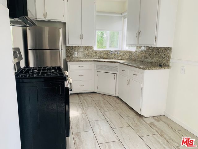 a kitchen with a refrigerator and a sink