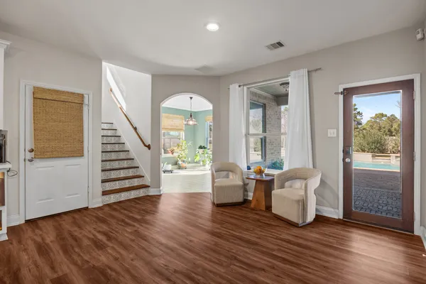 a view of a room with wooden floor and furniture