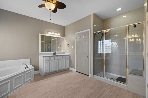 a bathroom with a double vanity sink toilet and shower