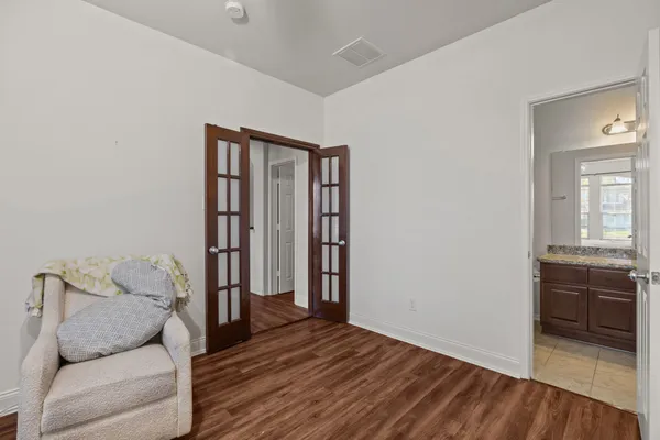 a hall way with furniture and wooden floor