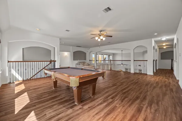 a living room with furniture a wooden floor and a chandelier