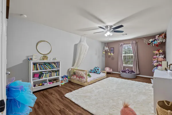 a living room with furniture toys and a book shelf