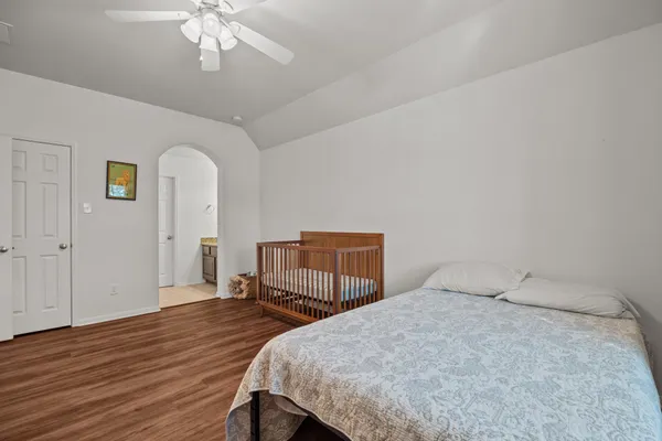 a bedroom with a bed and a chandelier