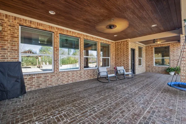 a view of a porch with chairs and a patio