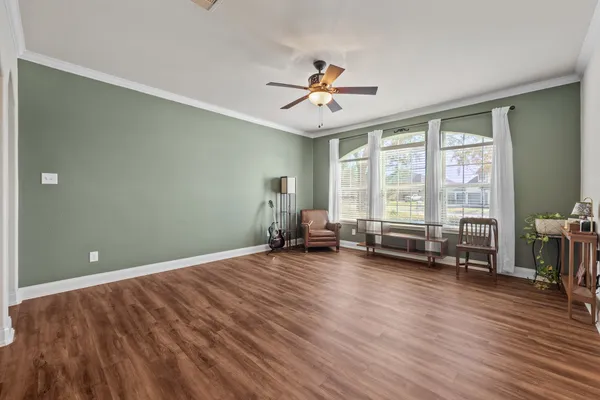wooden floor in an empty room with a window