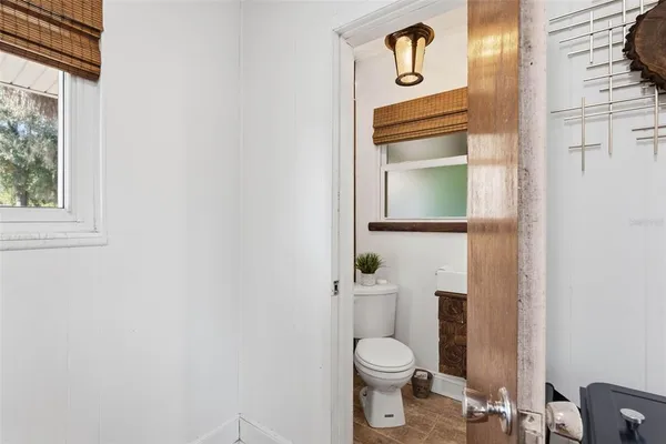 a bedroom with a large bed and a flat tv screen on dresser