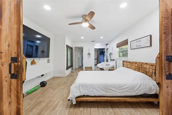 a bedroom with a bed and a flat screen tv