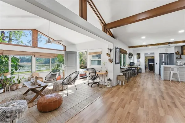 a living room with furniture a large window with wooden floor