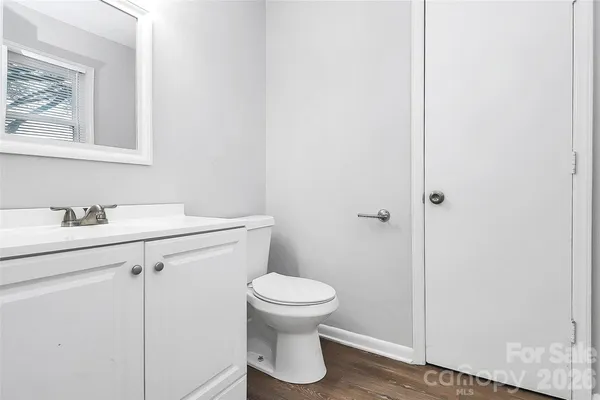 a bathroom with a toilet sink and a mirror