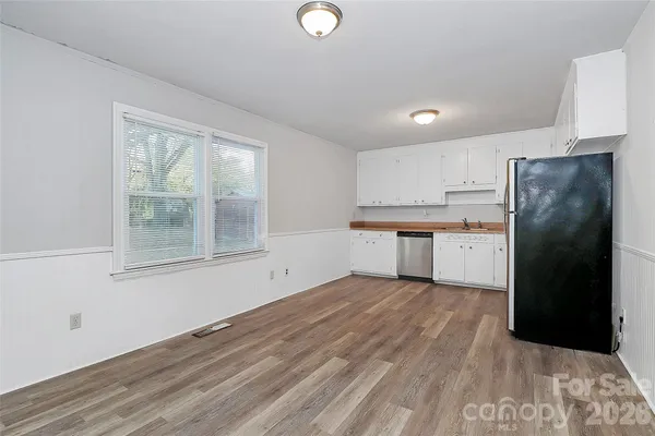 a view of a kitchen with a sink dishwasher and a refrigerator