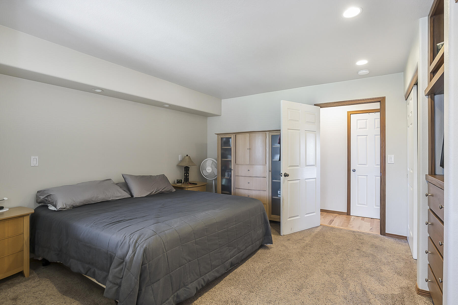 61030 Jennings Road Bend, OR 97702 - Photo 40 of 76 a bedroom with a bed and a refrigerator