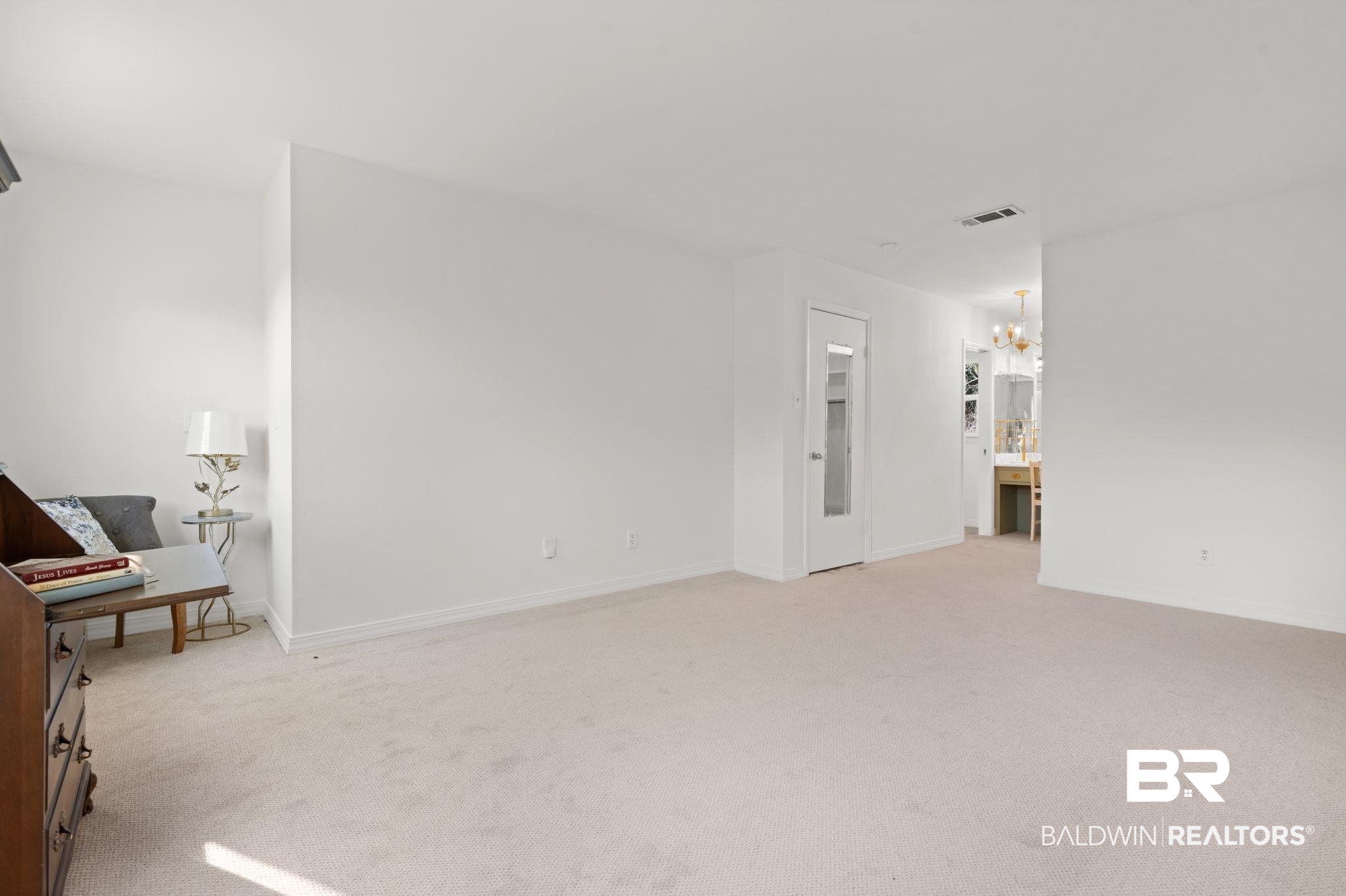 511 Wacker Lane North Mobile, AL 36608 - Photo 40 of 45 Unfurnished living room featuring light colored carpet and a chandelier
