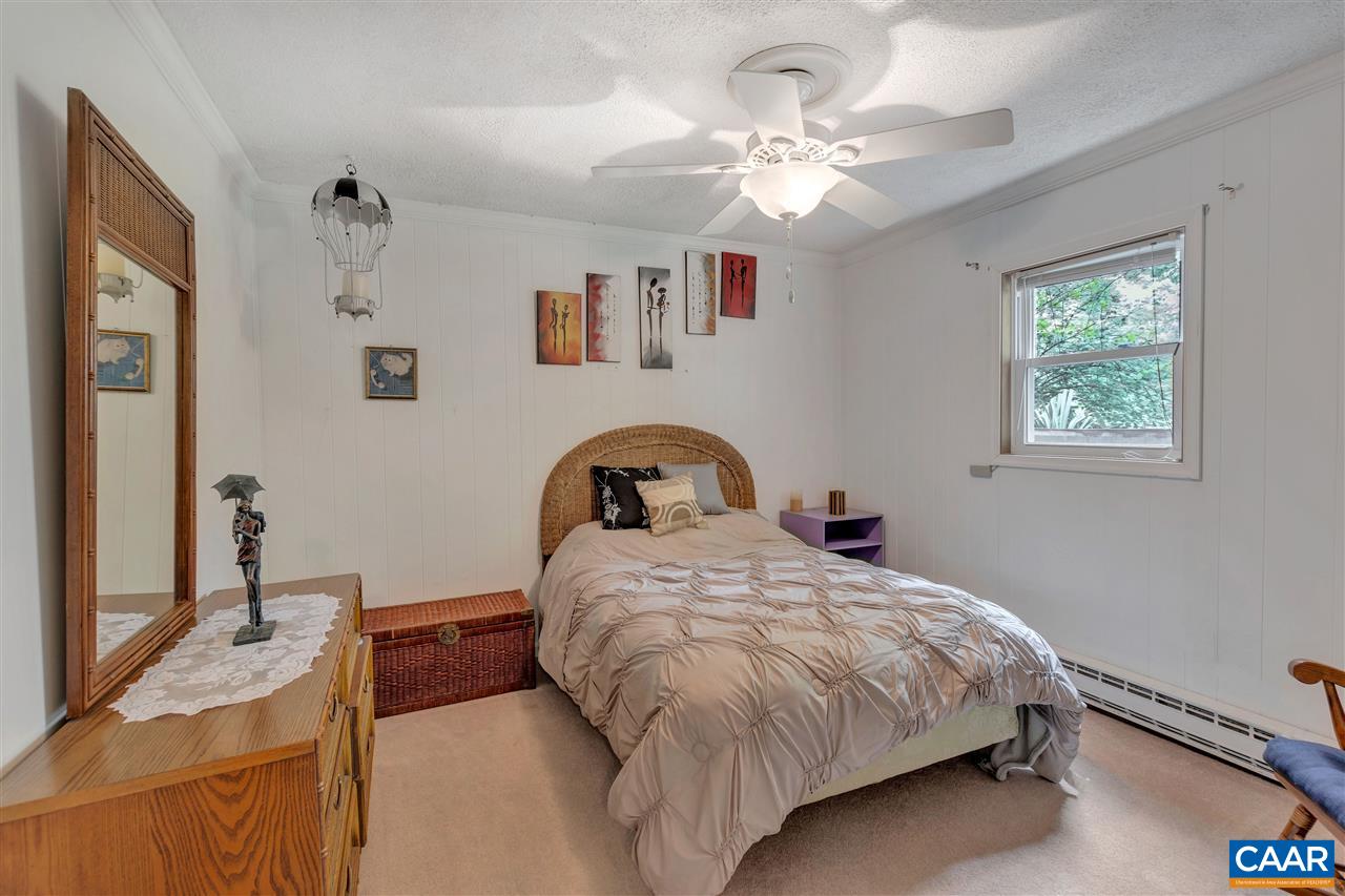 960 Claudius Court Crozet, VA 22932 - Photo 13 of 22 a bedroom with a bed and a chandelier